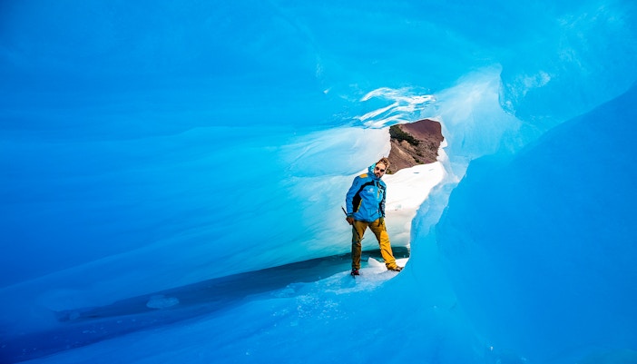 Tourist exploring ice caves at Big Ice, Perito Moreno Glacier, Argentina.