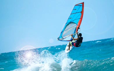 Windsurfer catching air over waves in Delta Neretva, Croatia.