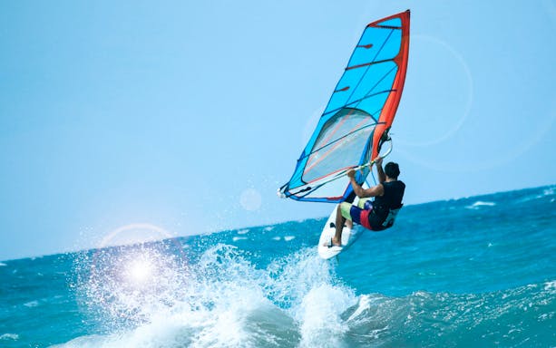 Windsurfer catching air over waves in Delta Neretva, Croatia.
