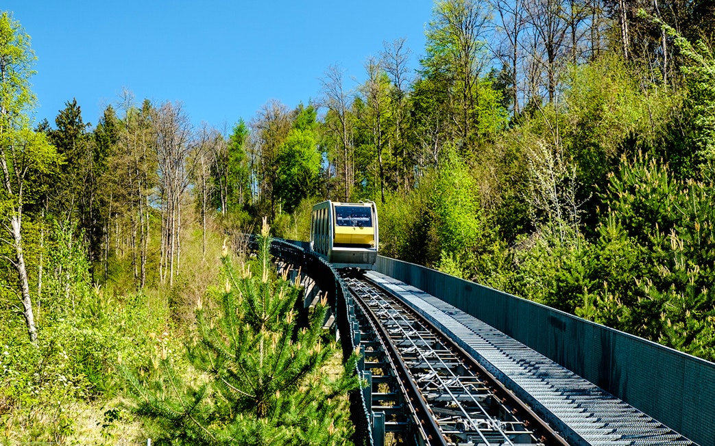 Hungerburg funicular traveling through lush forest in Austria.