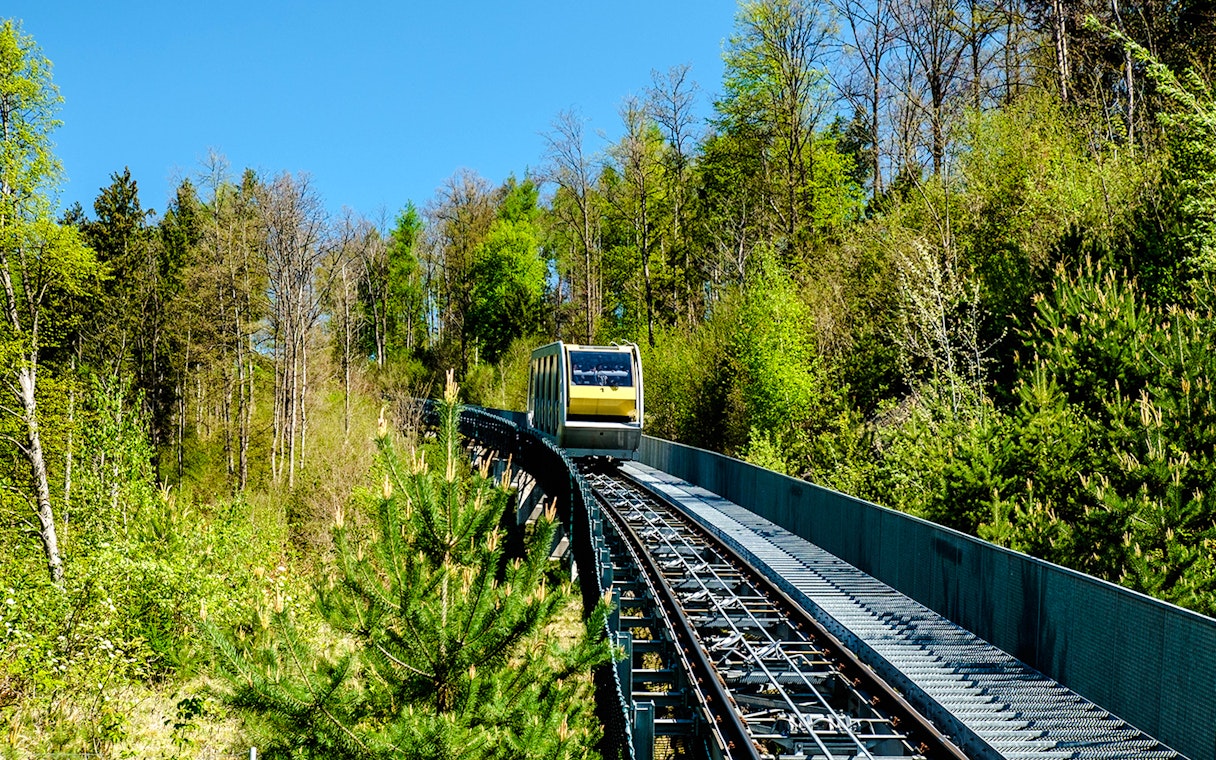 Hungerburg funicular traveling through lush forest in Austria.