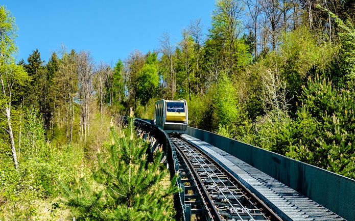 Hungerburg funicular traveling through lush forest in Austria.