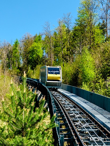 Hungerburg funicular traveling through lush forest in Austria.
