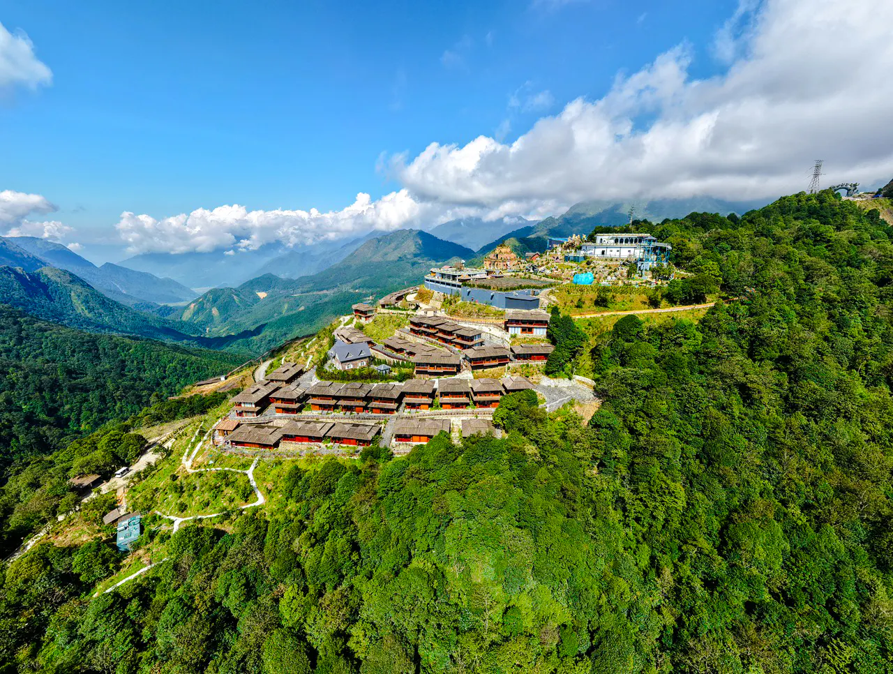 Aerial view of O Quy Ho Fairy Heaven Gate, Sa Pa, with mountain landscape and resort buildings.