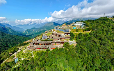 Aerial view of O Quy Ho Fairy Heaven Gate, Sa Pa, with mountain landscape and resort buildings.