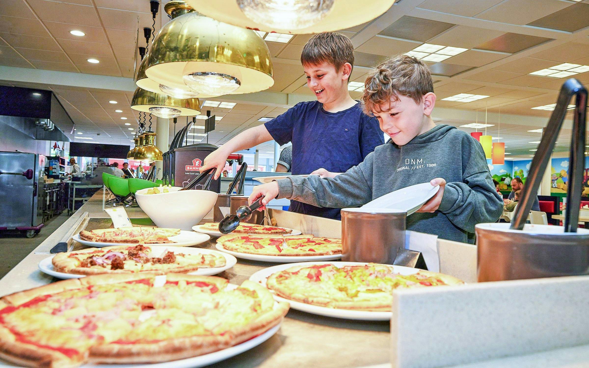 Children enjoying a pizza buffet at LEGOLAND® Billund restaurant.