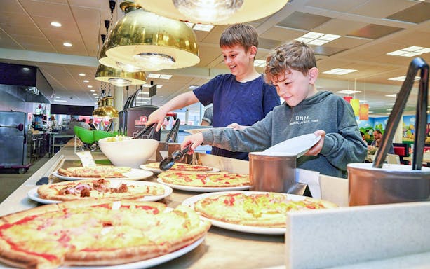 Children enjoying a pizza buffet at LEGOLAND® Billund restaurant.