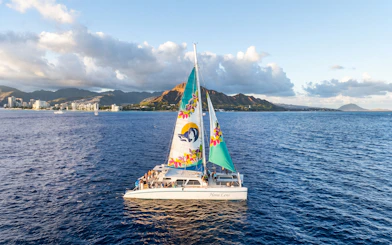 Catamaran sailing near Waikiki with Diamond Head in the background.