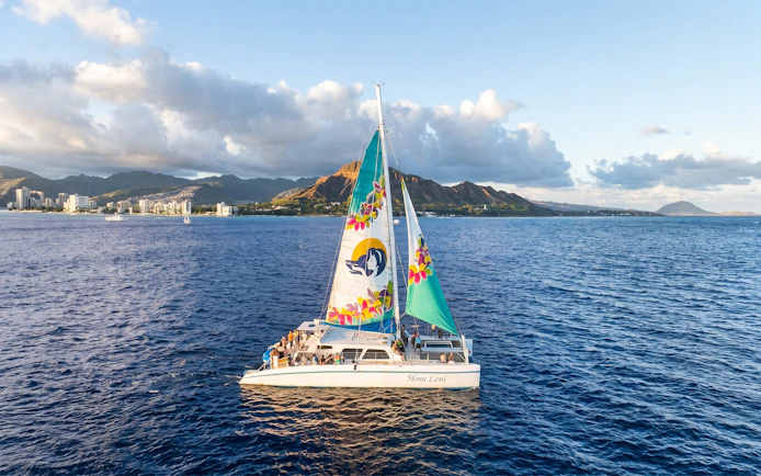 Catamaran sailing near Waikiki with Diamond Head in the background.