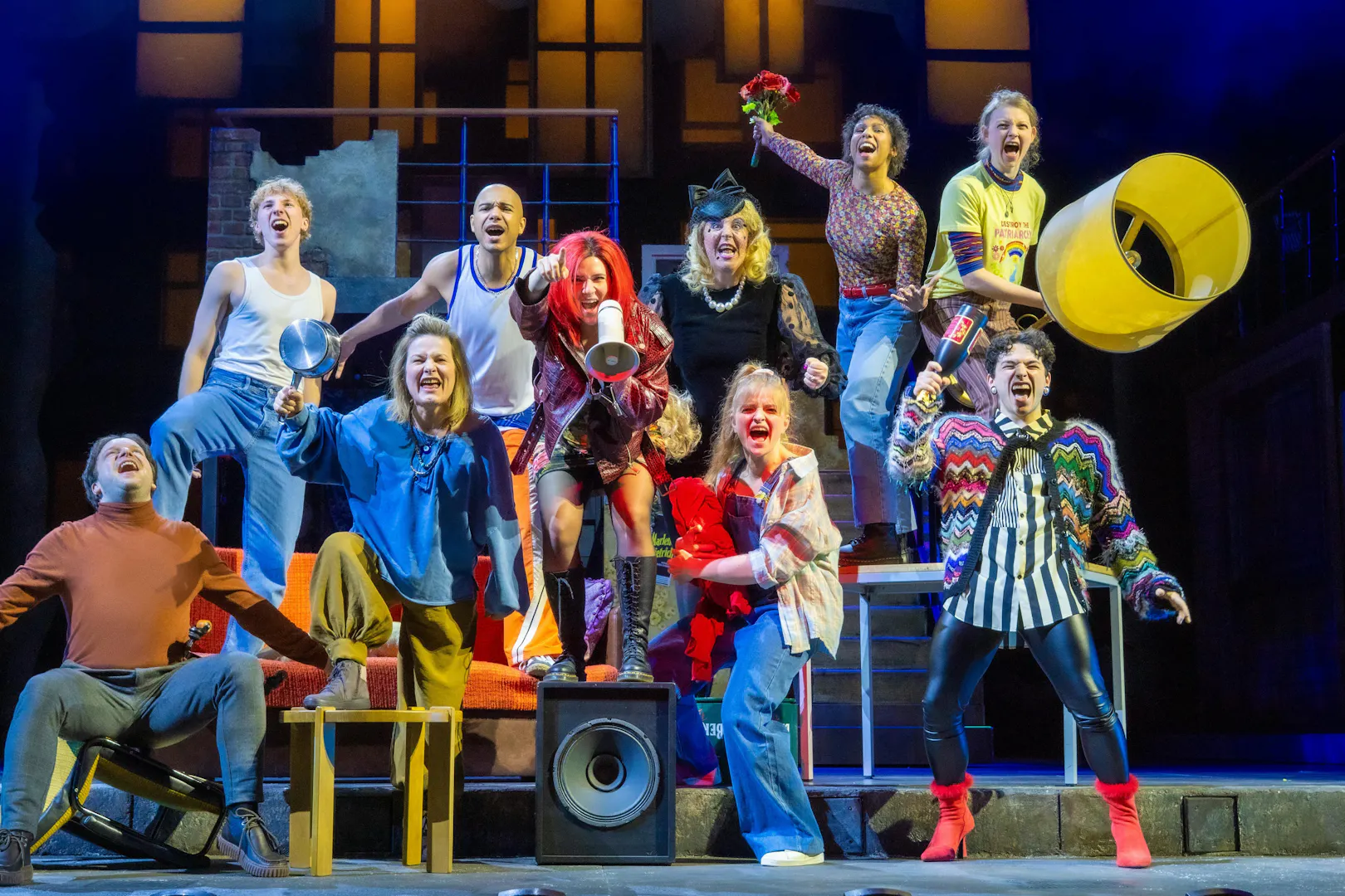Performers on stage during "We Are Alive" show in Berlin, expressing joy and energy.