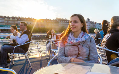 People enjoying a sunset cruise on the Vltava River in Prague.