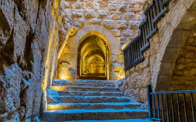 Steps leading through a stone corridor inside Ajloun Castle, Jordan.