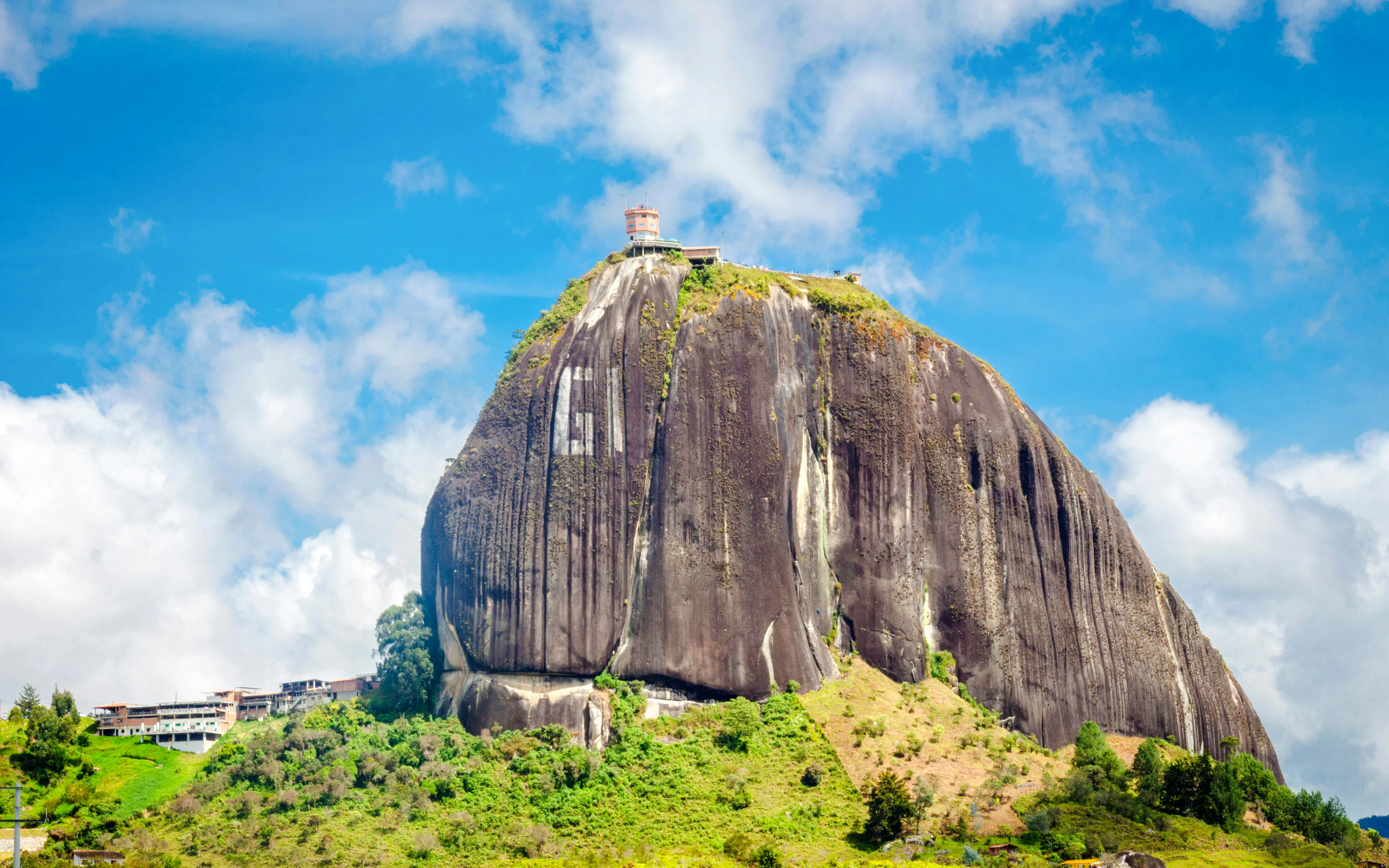 Piedra del Peñol towering over lush landscape in Guatapé, Antioquia, Colombia.