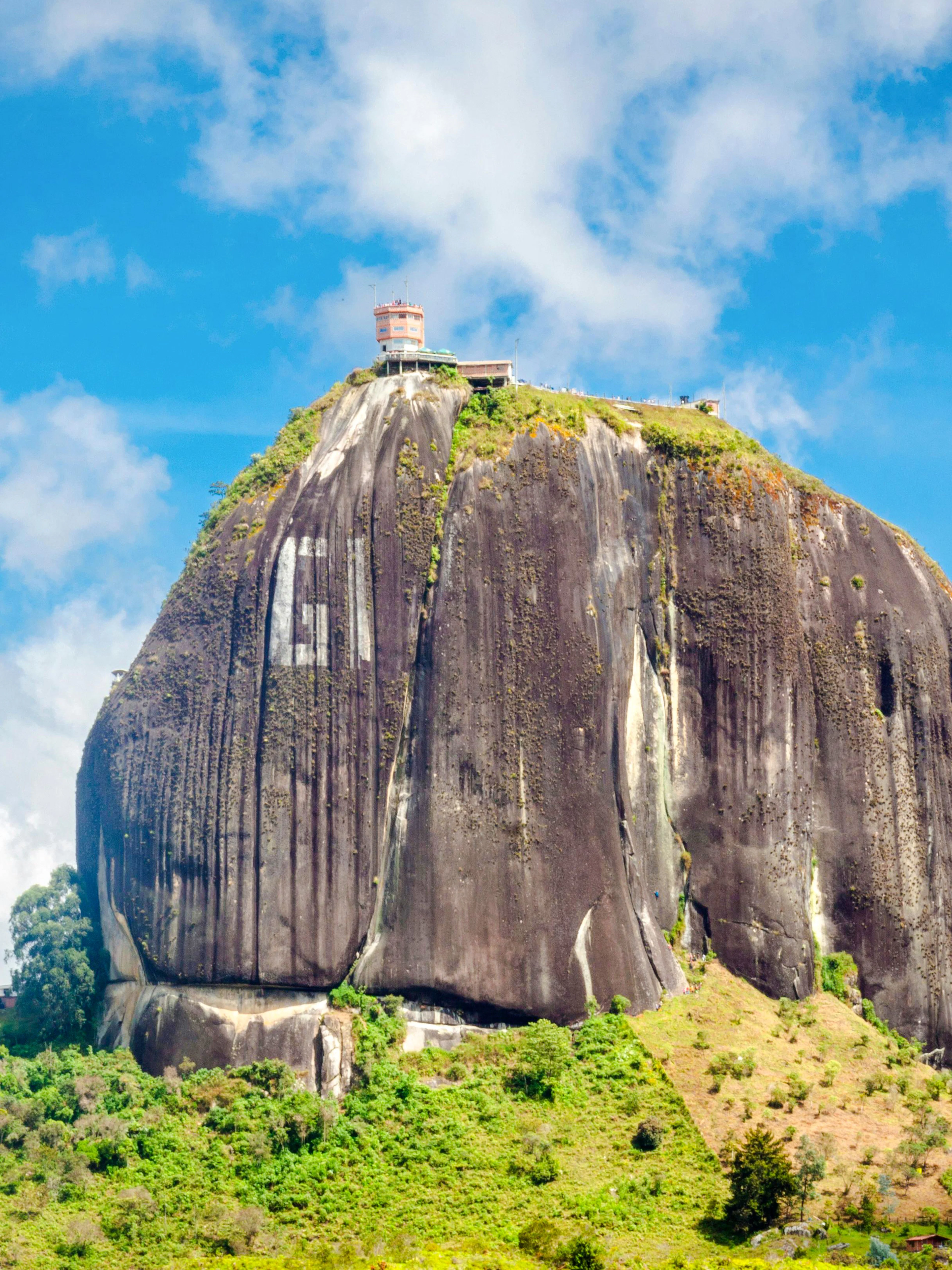 Piedra del Peñol towering over lush landscape in Guatapé, Antioquia, Colombia.