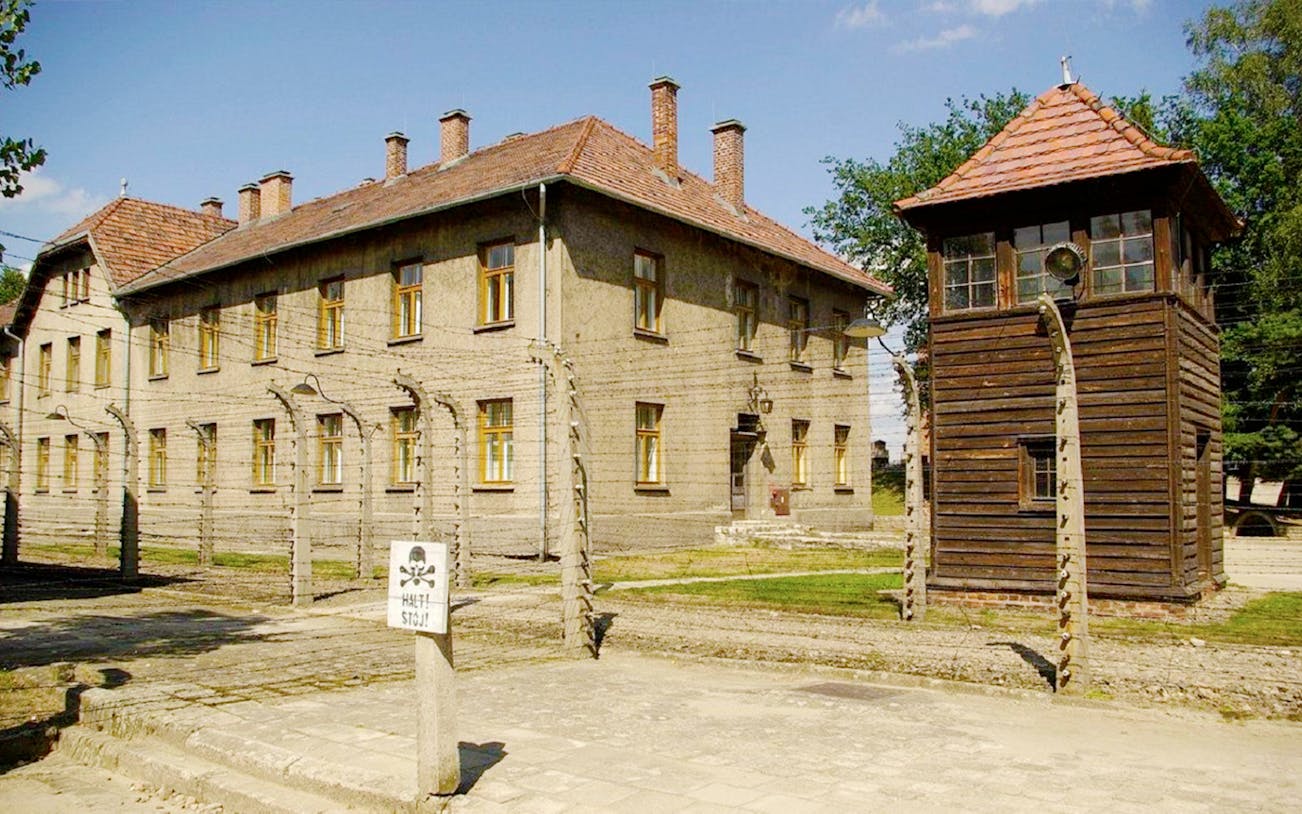 Auschwitz concentration camp building and watchtower on Krakow day tour from Warsaw.