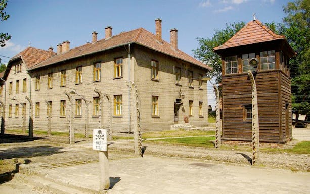 Auschwitz concentration camp building and watchtower on Krakow day tour from Warsaw.