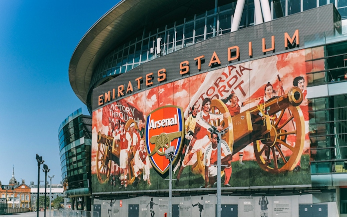 Emirates Stadium exterior with Arsenal mural, part of the Arsenal FC audio tour.