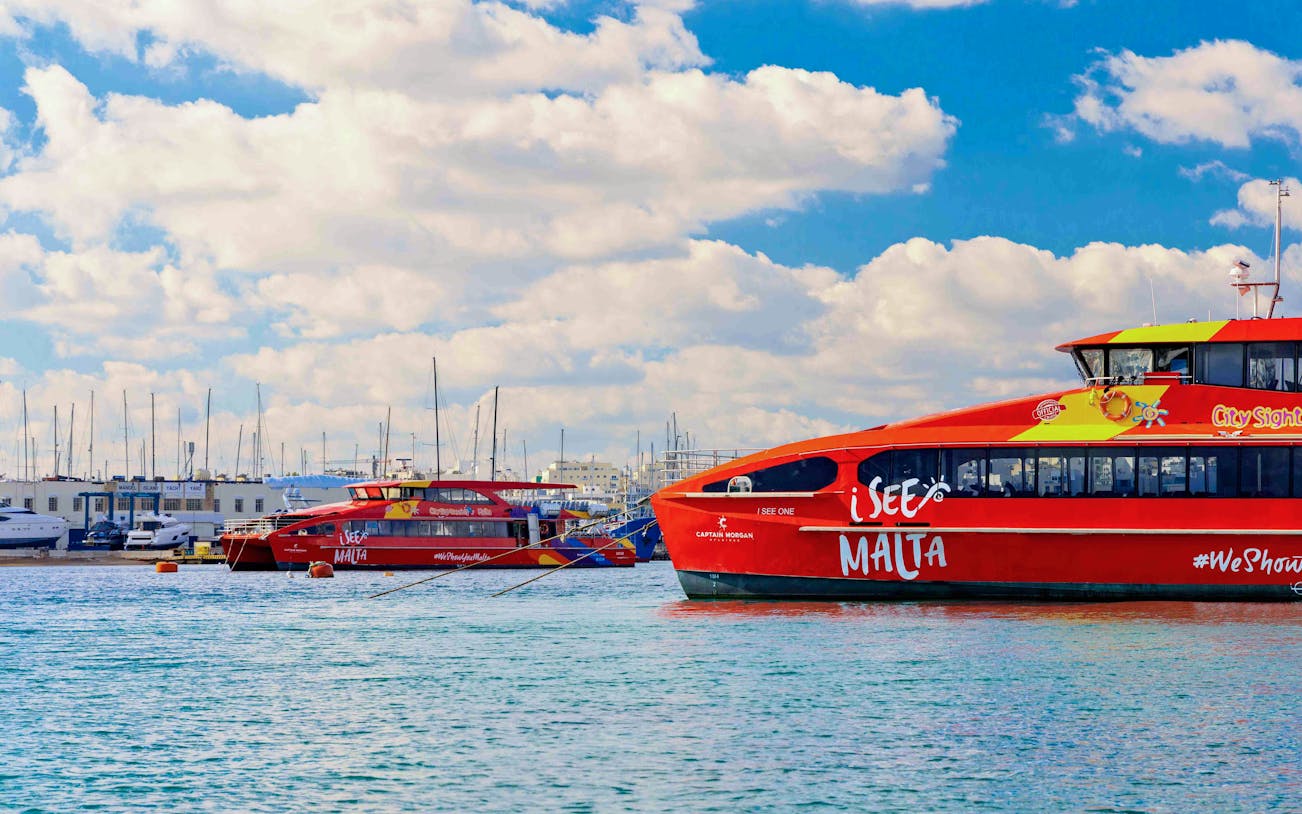 Cruises docked at the boarding area in Malta with clear skies.