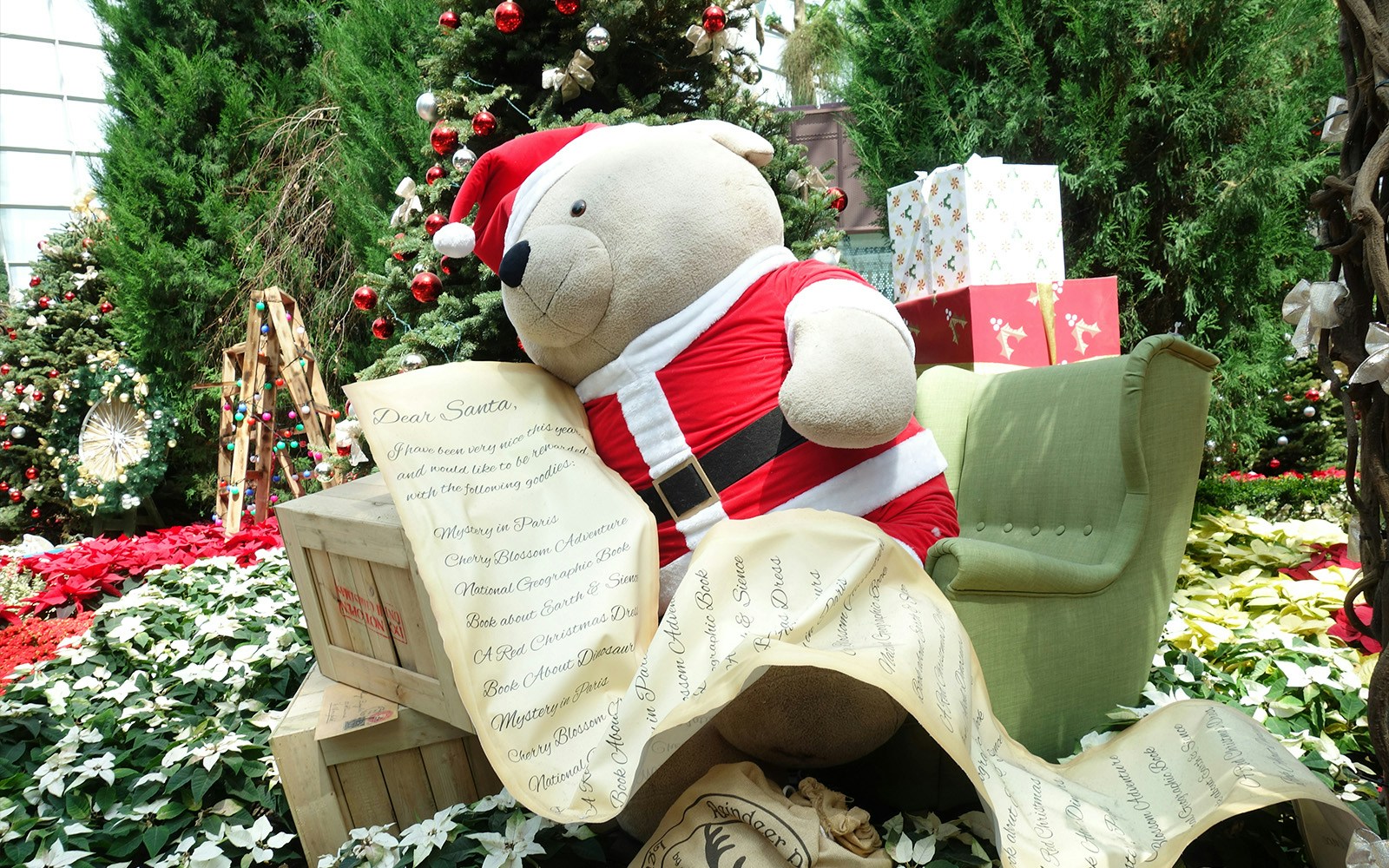Teddy bear in Santa outfit with Christmas list at Gardens by the Bay Christmas workshop.