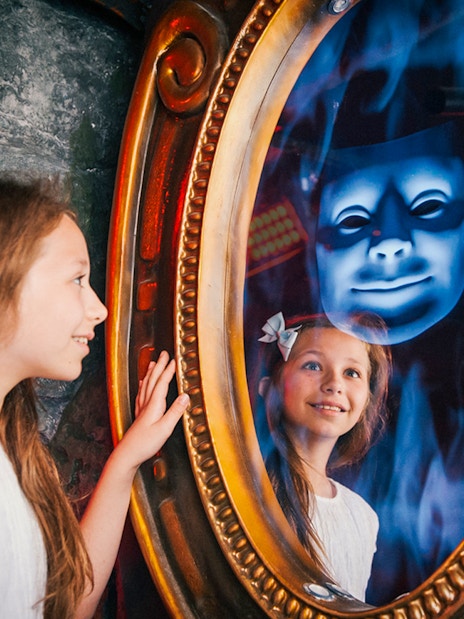 Child interacting with magic mirror at Shrek’s Adventure! London.
