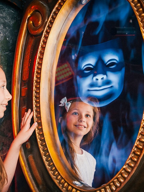Child interacting with magic mirror at Shrek’s Adventure! London.