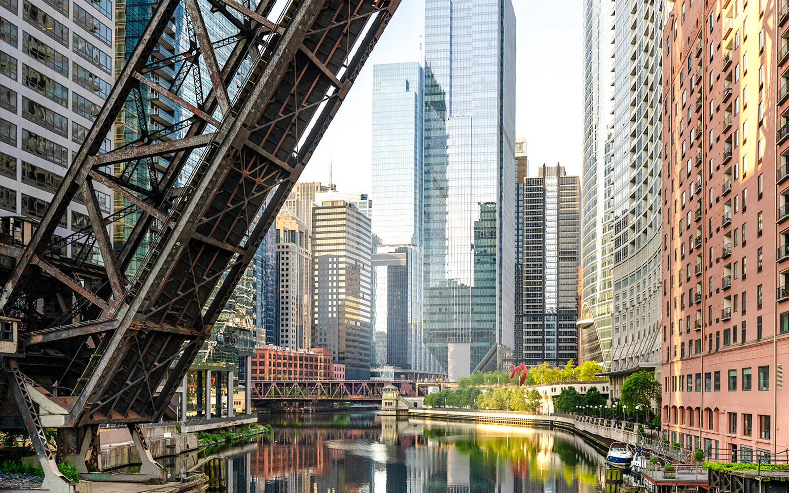 Downtown Chicago skyline with river and bridge in foreground.
