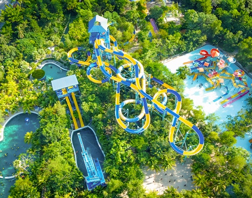 Visitors enjoying thrilling rides at ESCAPE Theme Park Penang, a popular tourist attraction in Malaysia