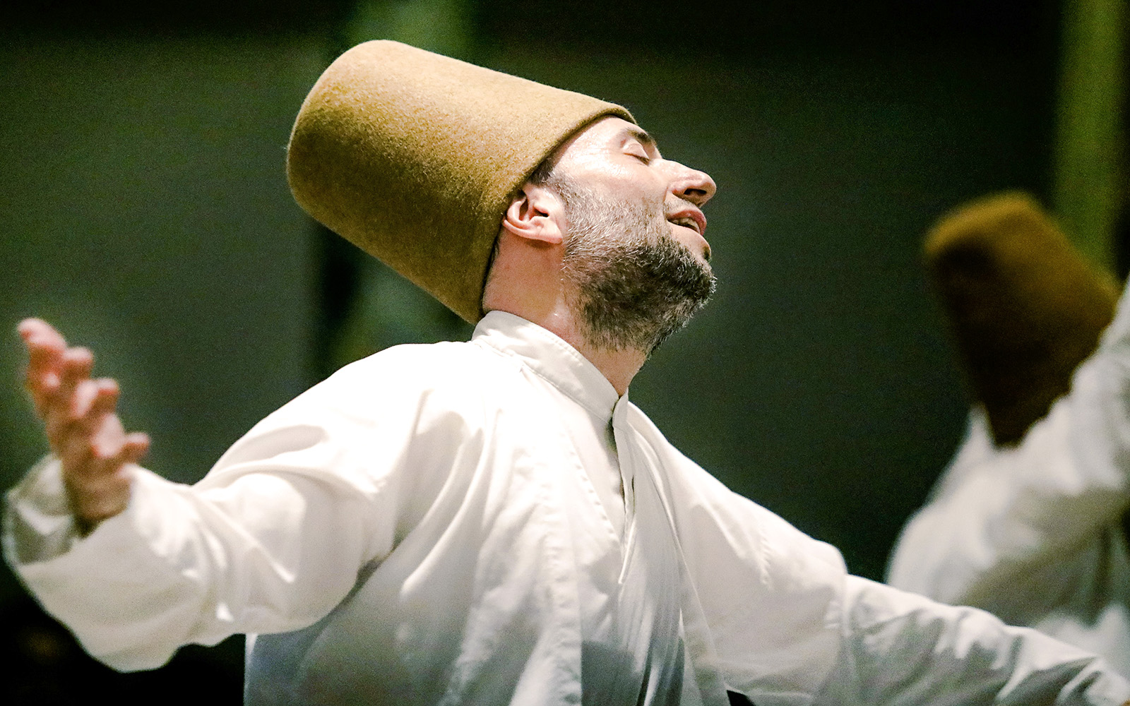 Whirling Dervish performing in traditional attire during a ceremony in Istanbul.