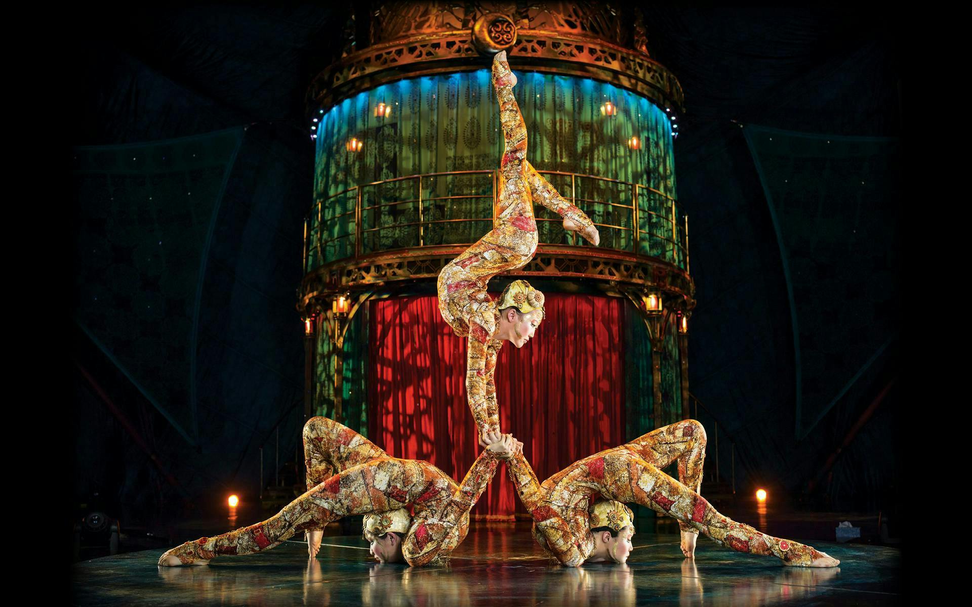 Acrobats performing a balancing act in Kooza stage show.