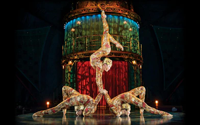 Acrobats performing a balancing act in Kooza stage show.