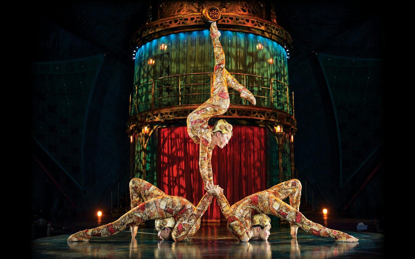 Acrobats performing a balancing act in Kooza stage show.