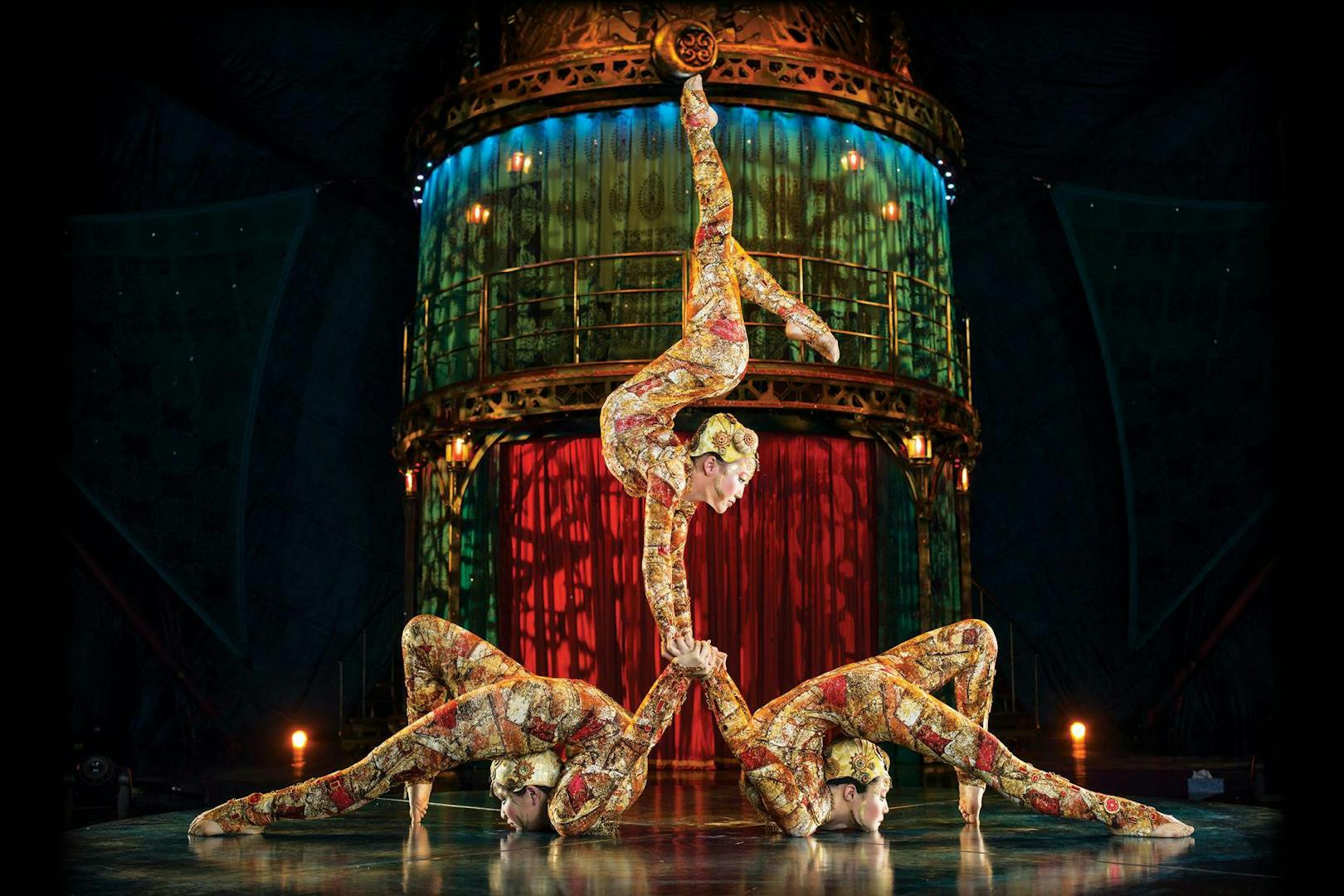 Acrobats performing a balancing act in Kooza stage show.