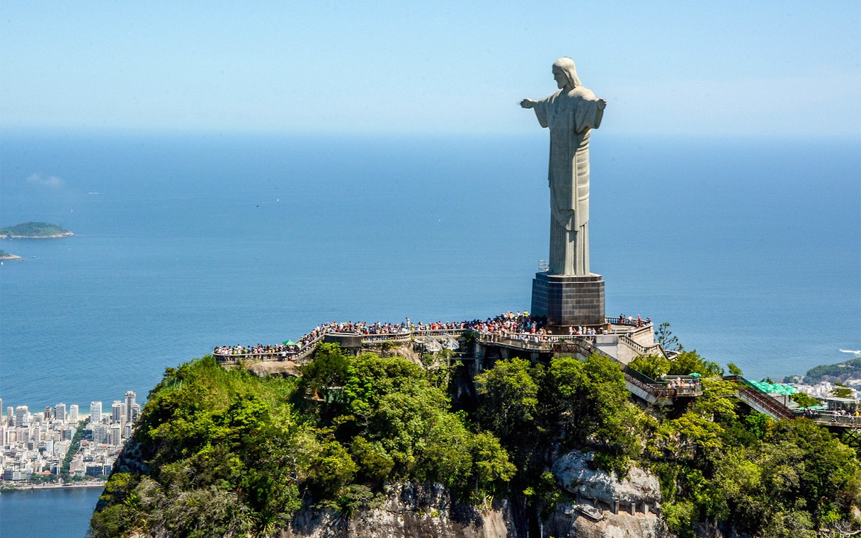 Christ the Redeemer statue overlooking Rio de Janeiro, Brazil, with ocean view.
