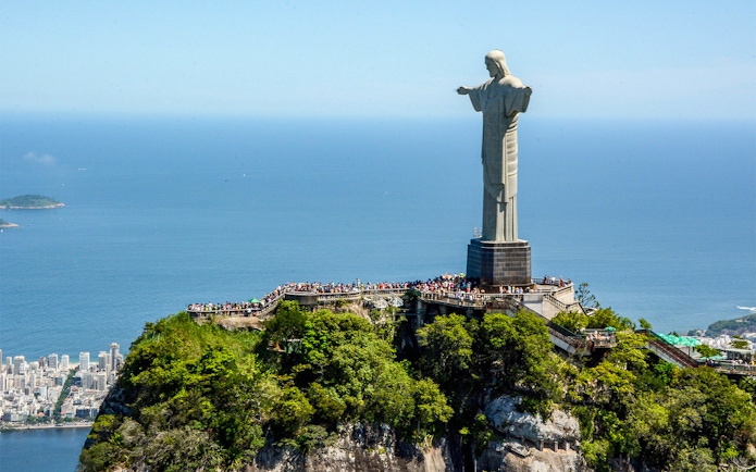 Christ the Redeemer statue overlooking Rio de Janeiro, Brazil, with ocean view.
