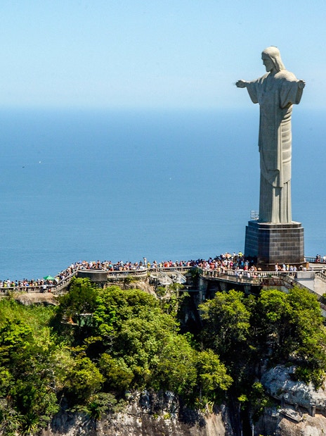 Christ the Redeemer statue overlooking Rio de Janeiro, Brazil, with ocean view.
