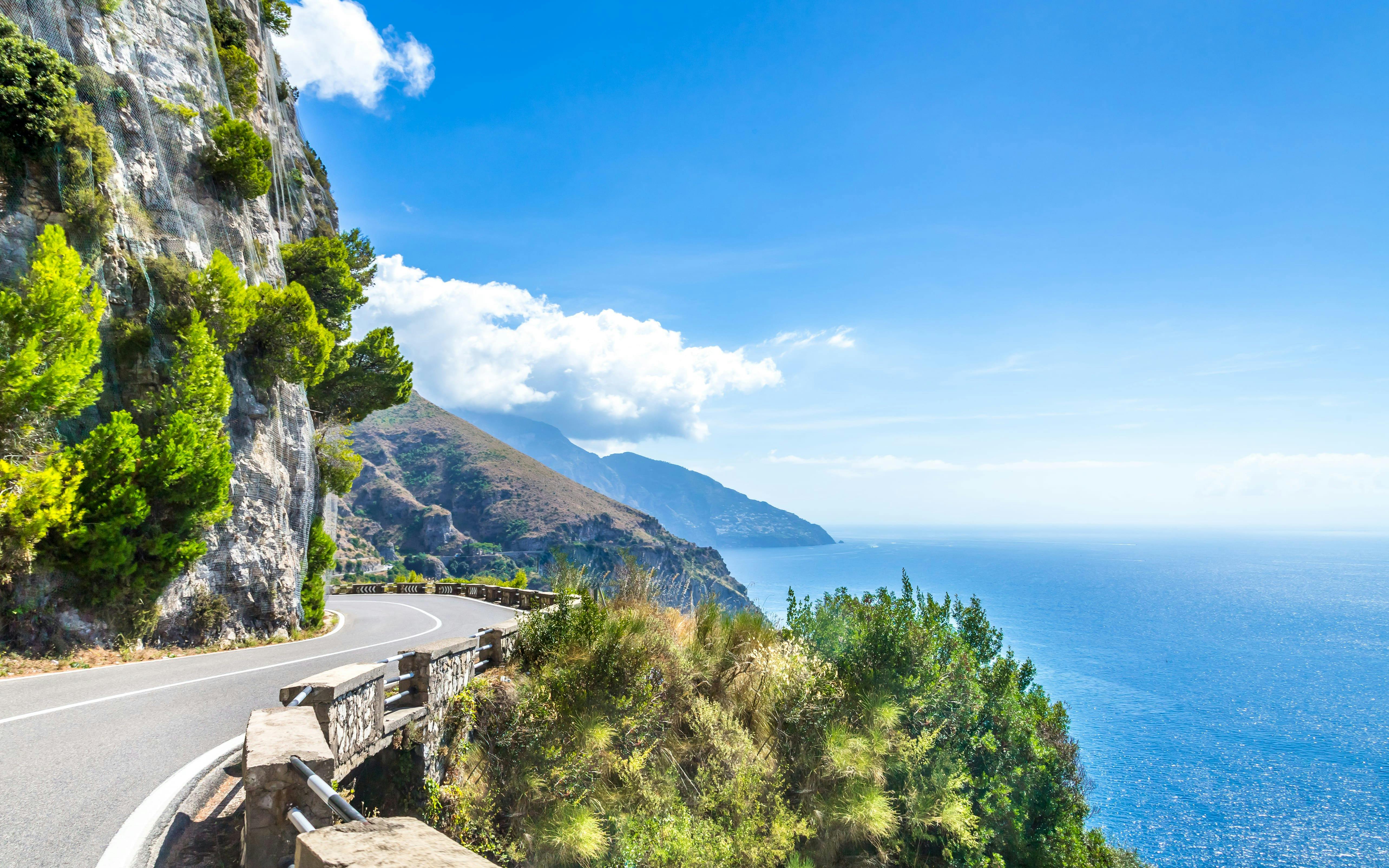 Coastal road along cliffs with sea view on the Amalfi Coast, Italy.