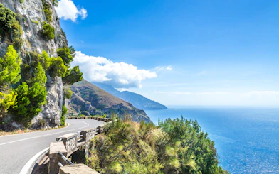 Coastal road along cliffs with sea view on the Amalfi Coast, Italy.