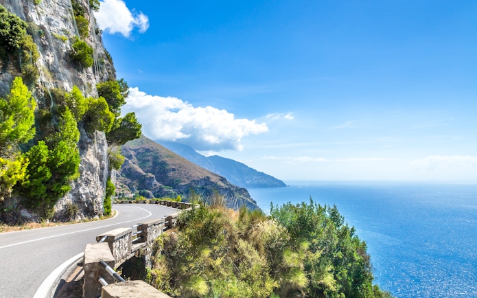 Coastal road along cliffs with sea view on the Amalfi Coast, Italy.