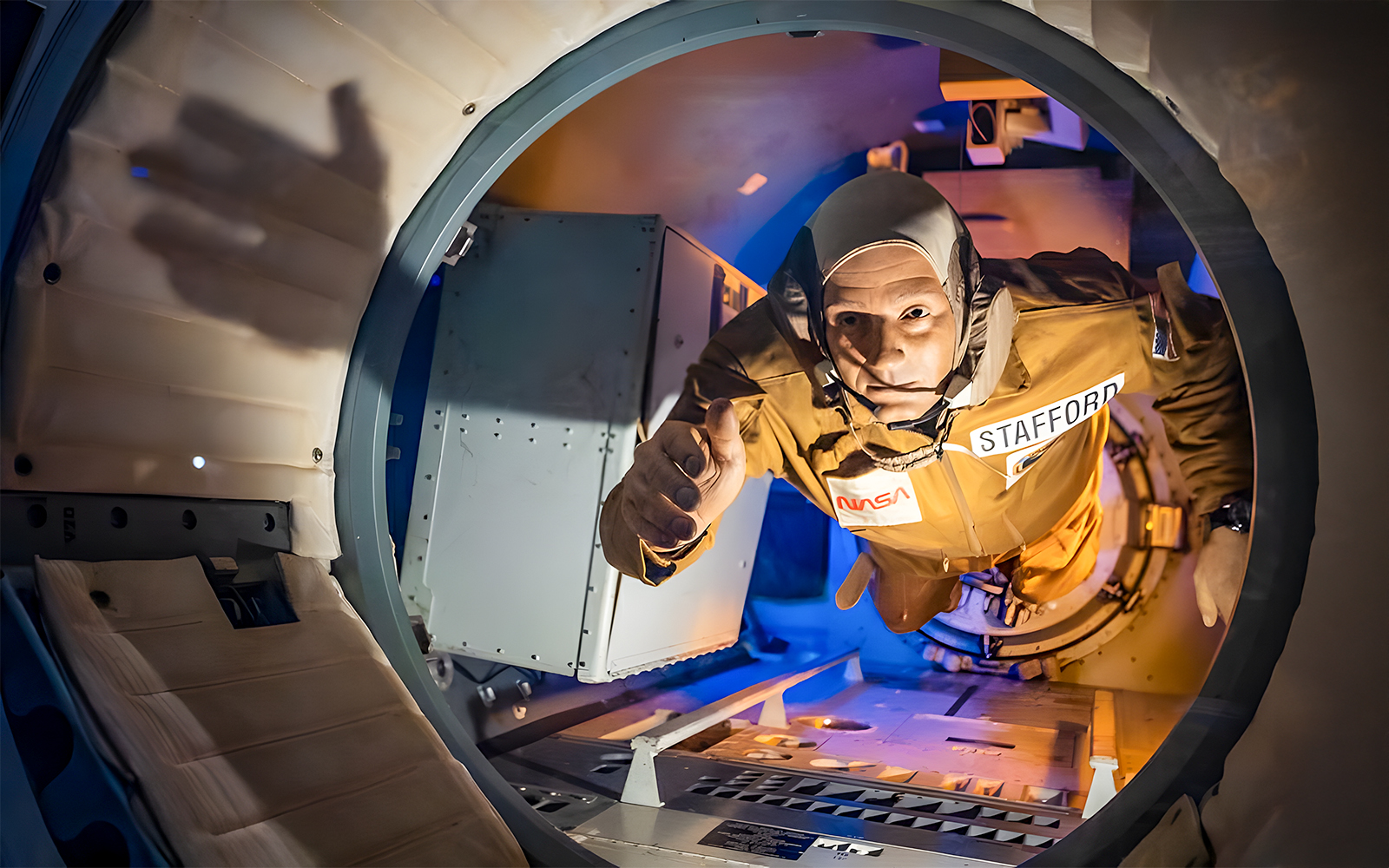 A wax figurine of Stafford reaching his hand out of the rocket at Houston Space Center