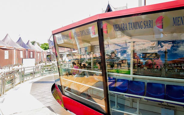 Menara Taming Sari observation deck with tourists in Melaka, Malaysia.