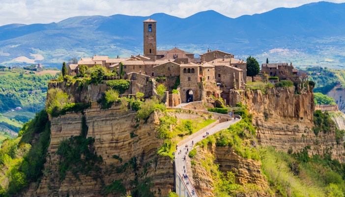 Civita di Bagnoregio perched on a hilltop in Viterbo, Italy, surrounded by lush valleys.
