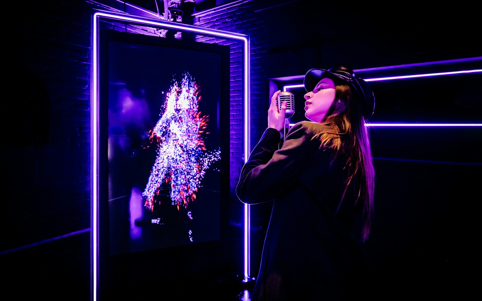 Tourist engaging with digital art at Audiovisual Experience in Amaze Amsterdam.