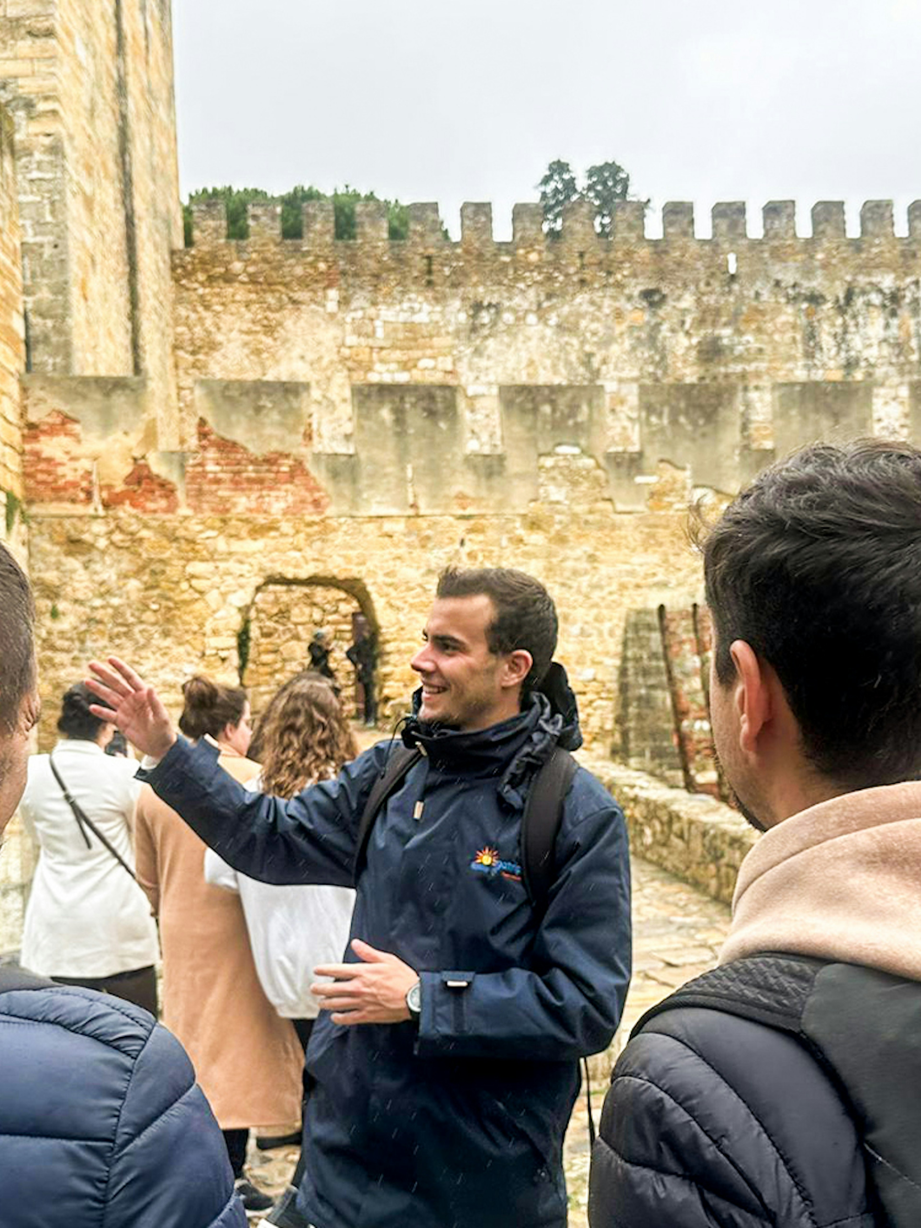 Tour guide leading a group at São Jorge Castle, Lisbon.