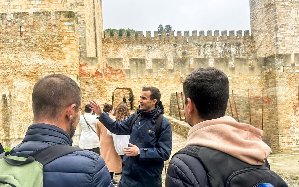 Tour guide leading a group at São Jorge Castle, Lisbon.