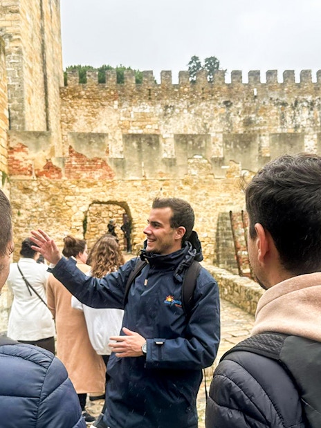 Tour guide leading a group at São Jorge Castle, Lisbon.
