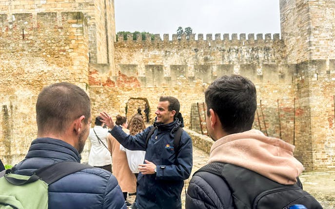 Tour guide leading a group at São Jorge Castle, Lisbon.