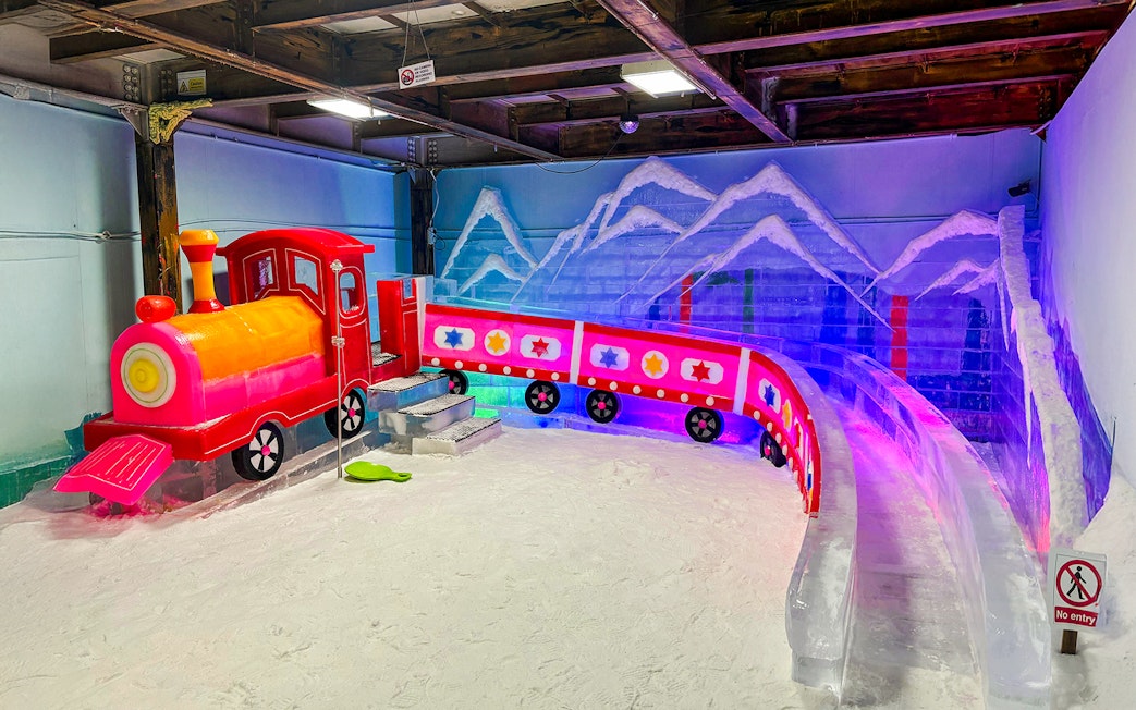 Coloured train and slide at Rainbow Frosty Playground, Singapore Snow City.