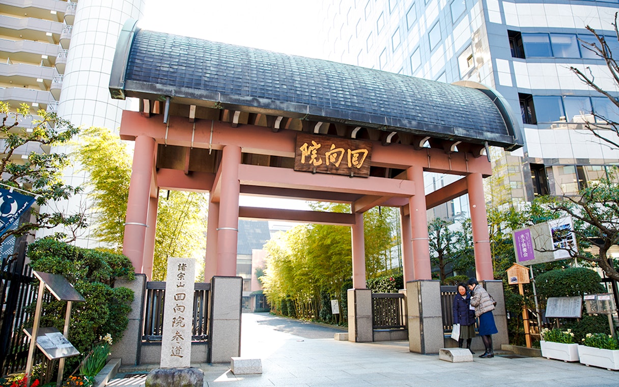 Entrance to Ryogoku Kokugikan sumo stadium in Tokyo, Japan, with traditional gate and signage.