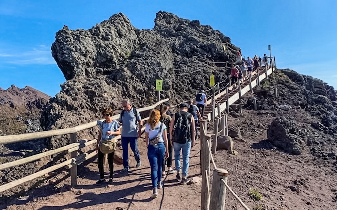 Tourists hiking on a trail at Mount Vesuvius, Italy.