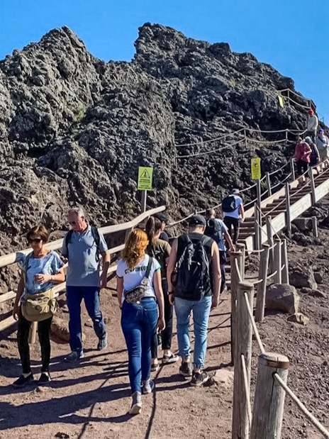 Tourists hiking on a trail at Mount Vesuvius, Italy.